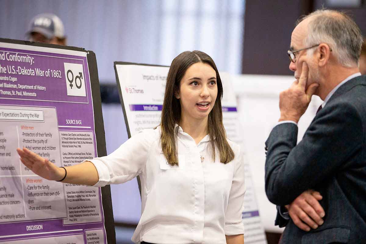 A students presents her findings during the Undergraduate Research Poster Session.