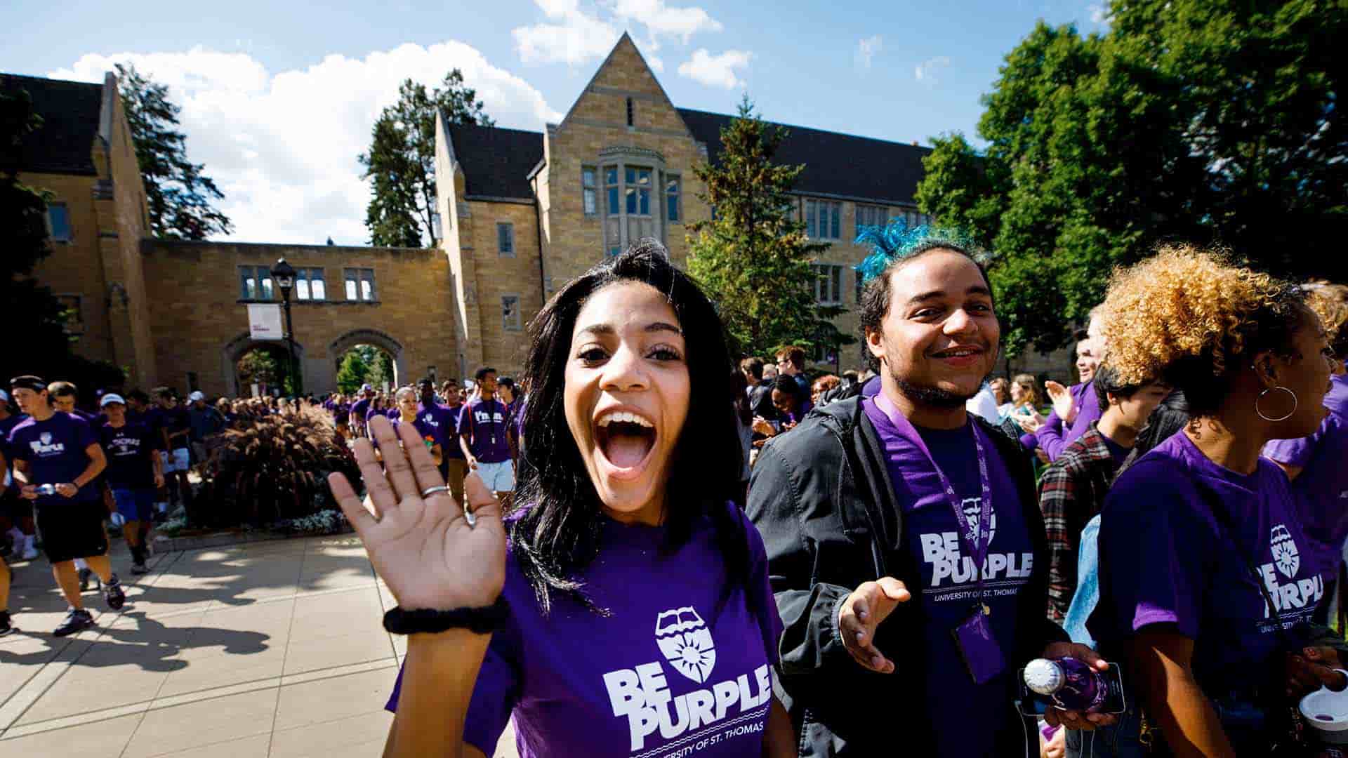 First-year students march through the arches on the St. Paul, University of St. Thomas campus.