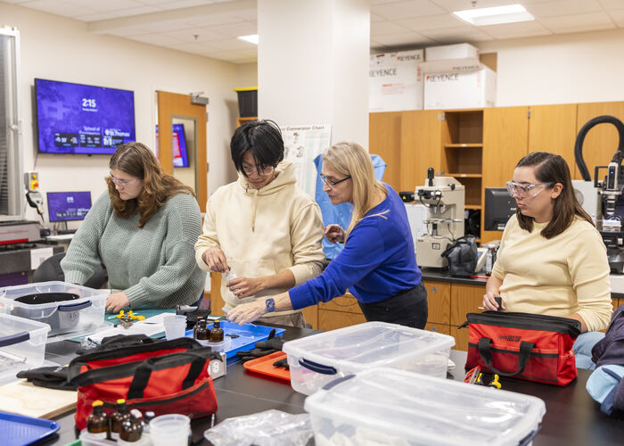 professor works with students in the materials engineering lab