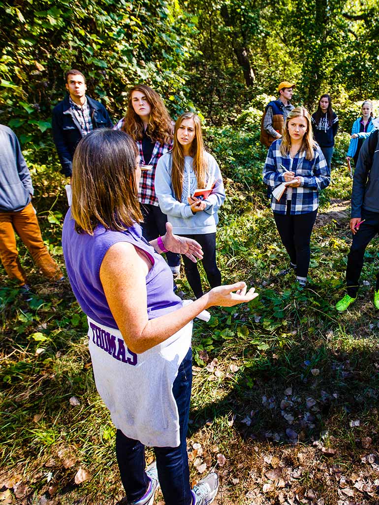 Geology professor Lisa Lamb instructs members of the Sustainability Living Learning Community (LLC) during a soils lab at Hidden Falls Park.