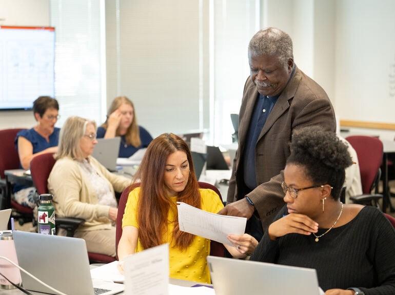 Students engage with professor during Opus executive education class 