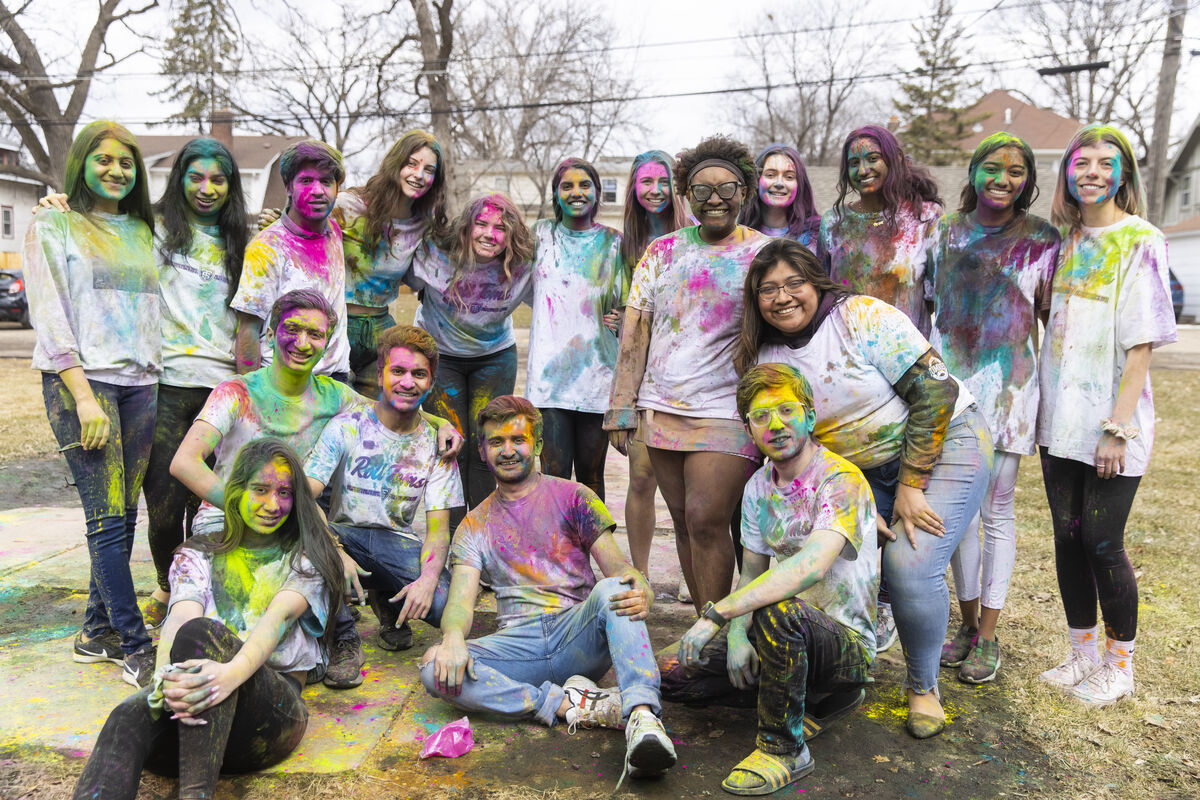 students wearing colorful pigments in celebration of Holi