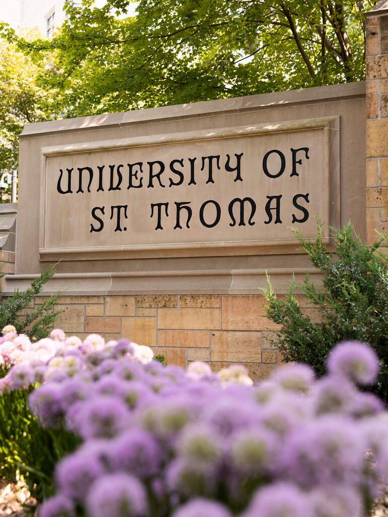 St. Thomas sign with flowers nearby