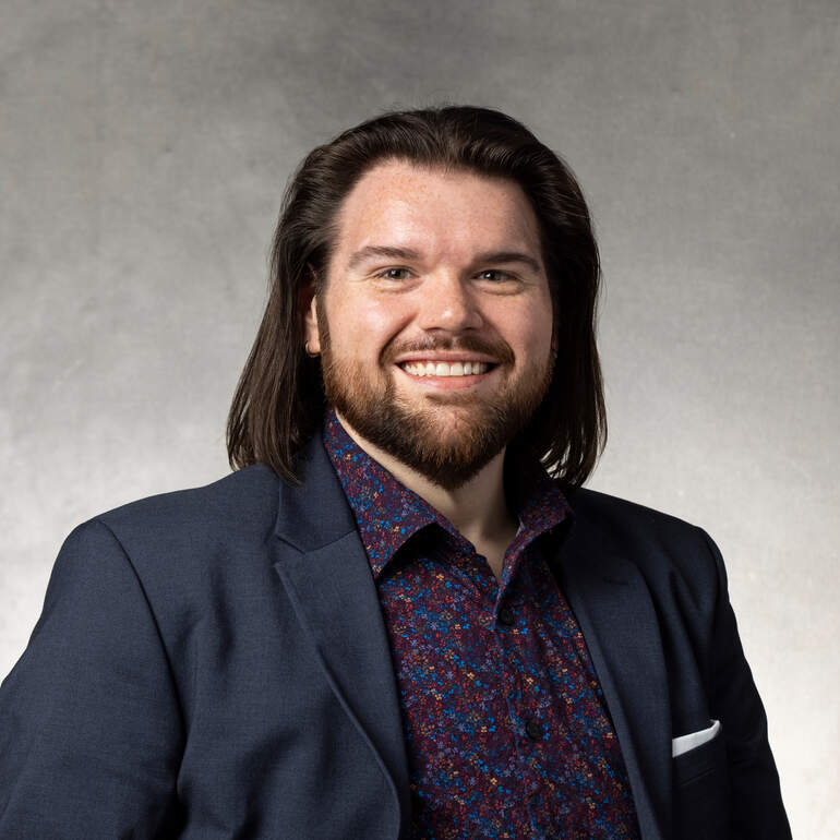 Studio headshot of Justin DeLong, Admissions Counselor