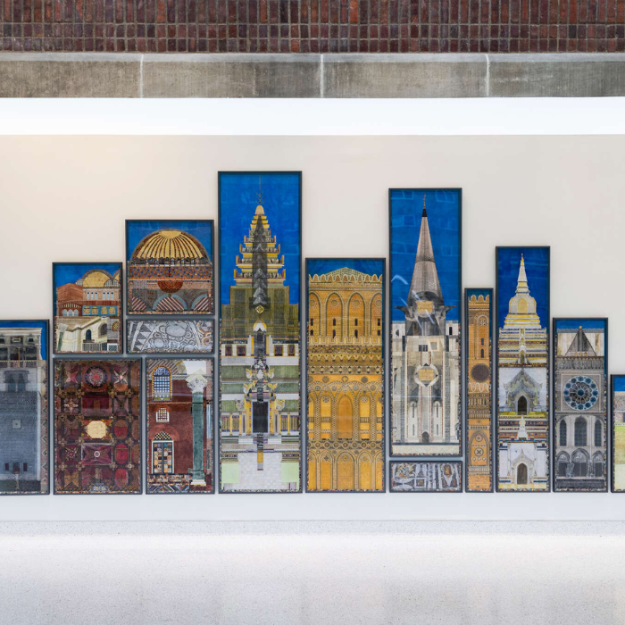A large mosaic-style wall artwork features vertically framed panels depicting architectural elements from religious buildings around the world. The designs include domes, towers, and intricate facades, celebrating global religious diversity and sacred spaces against a bold blue background.
