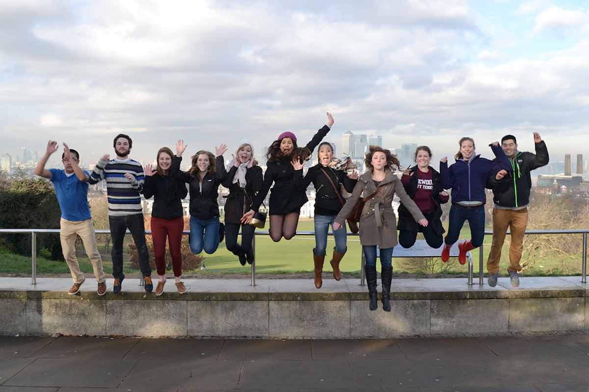 Students in London jumping in photo.
