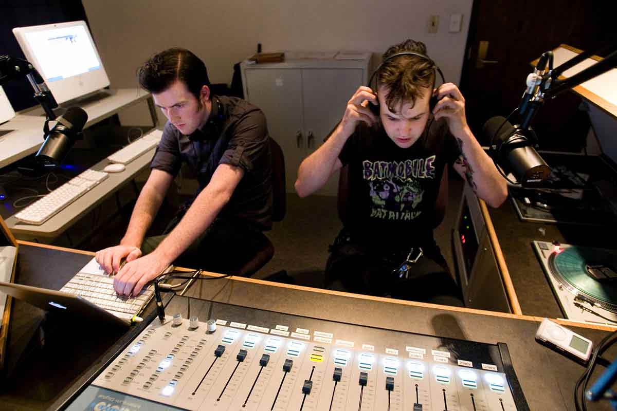 Students run a switchboard in the KUST studio.
