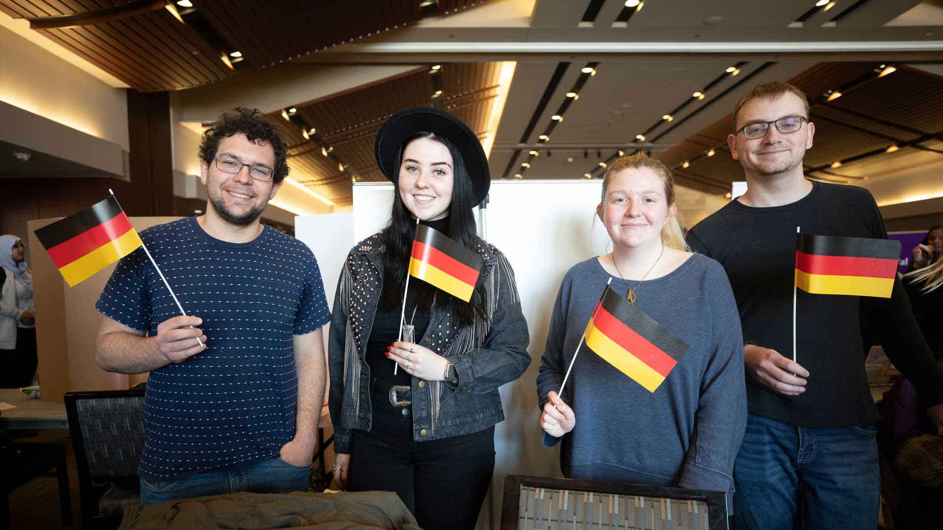 Members of the German Club pose with mini German flags at the annual involvement fair.