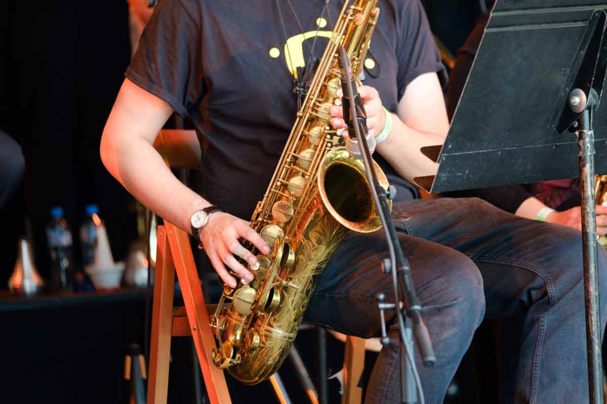 A close-up of a saxophone player performing on set.