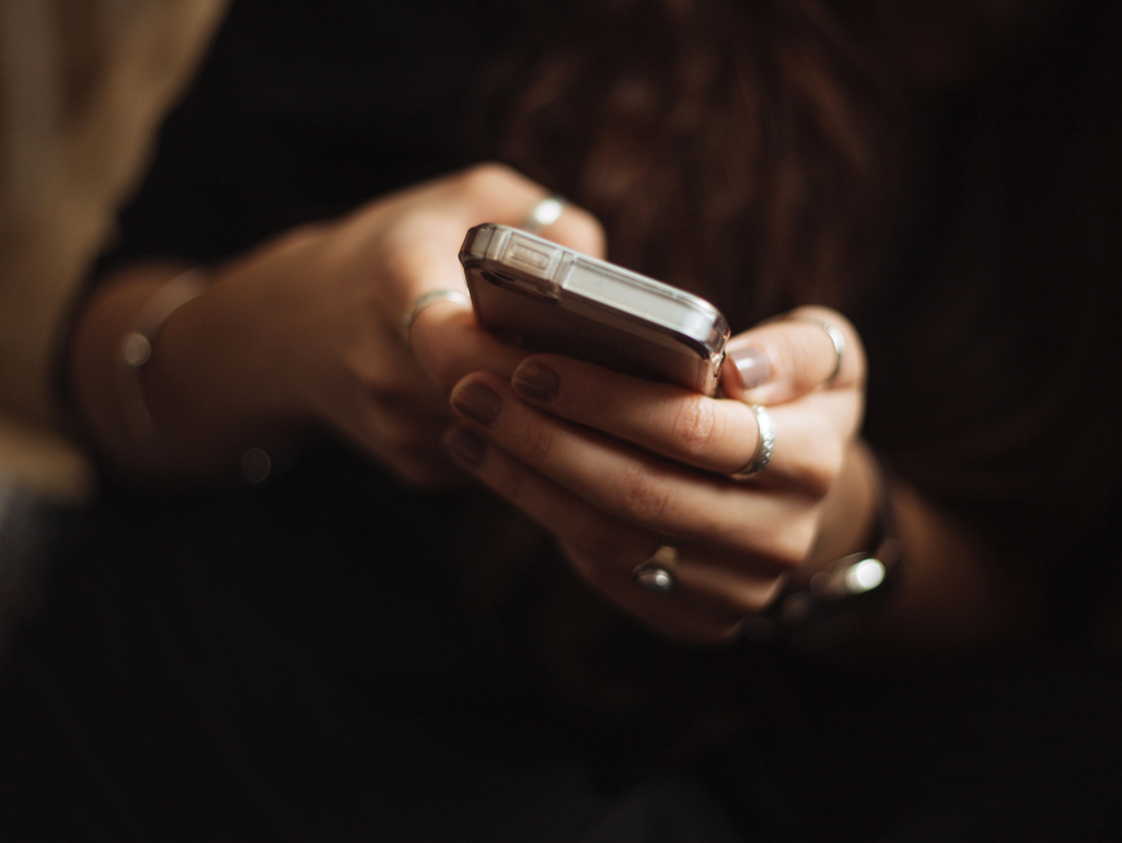 hands holding cell phone
