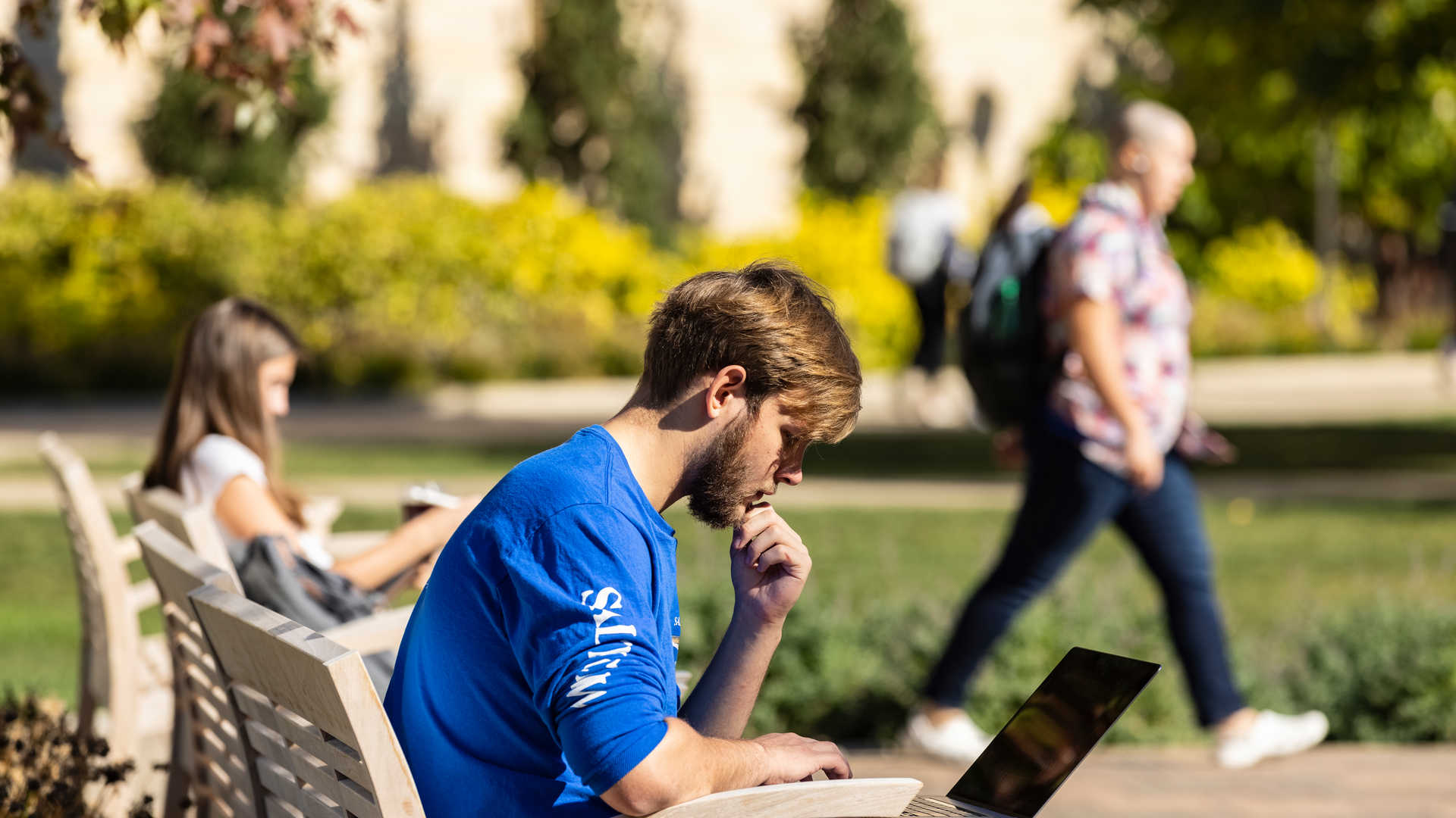 Student studying (looking pensive) outside on the plaza 