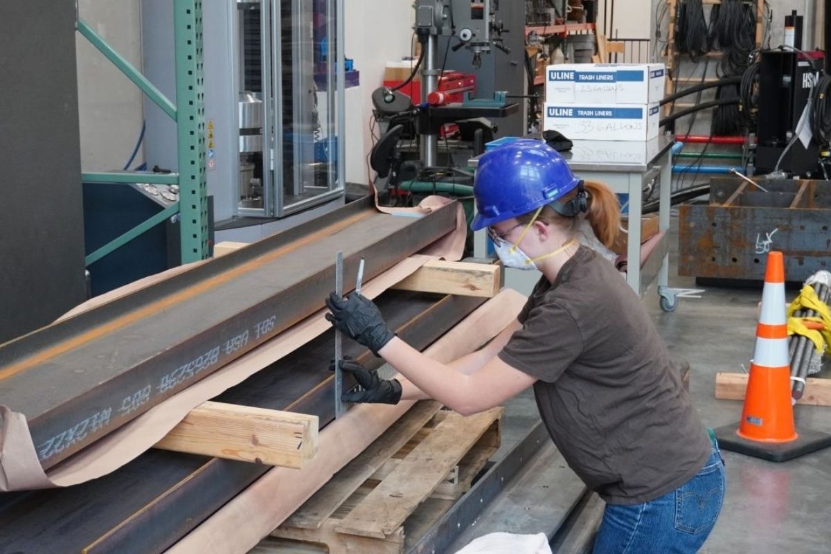 St. Thomas civil engineering student takes measurements on a steel beam