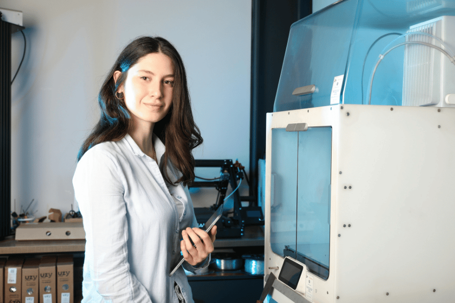 Woman working with a 3D printer