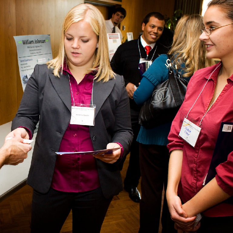 Students speak with employers at a job fair.