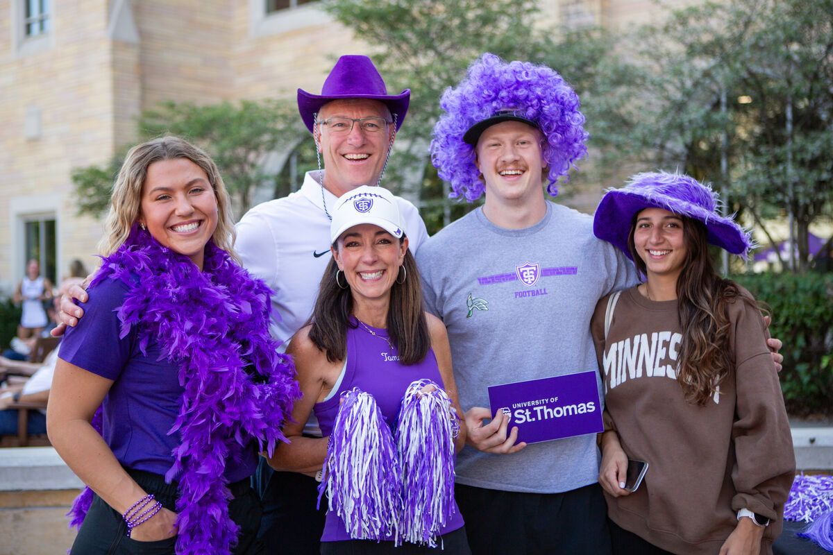 Family smiling with purple props