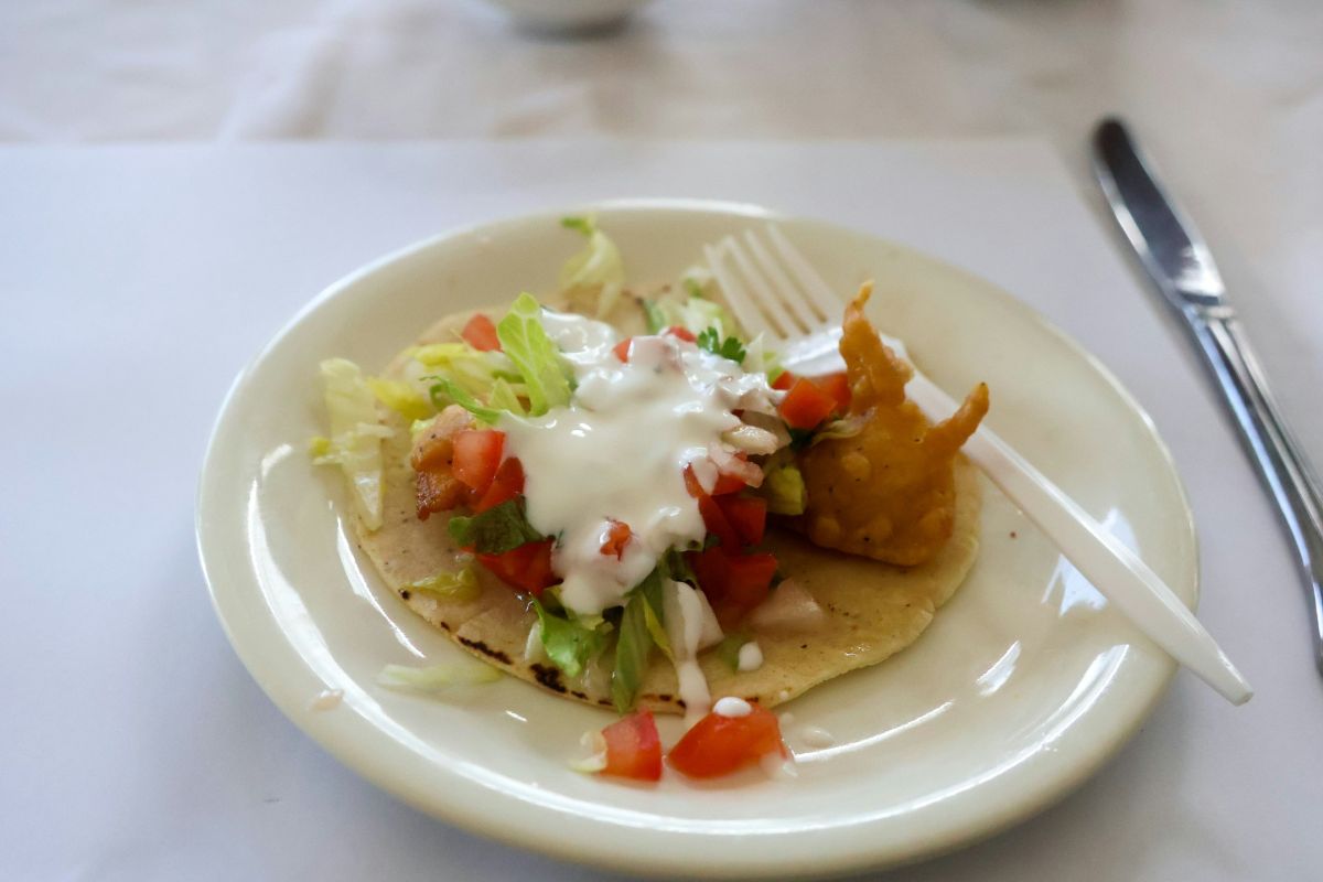 Small taco with plastic fork on plate