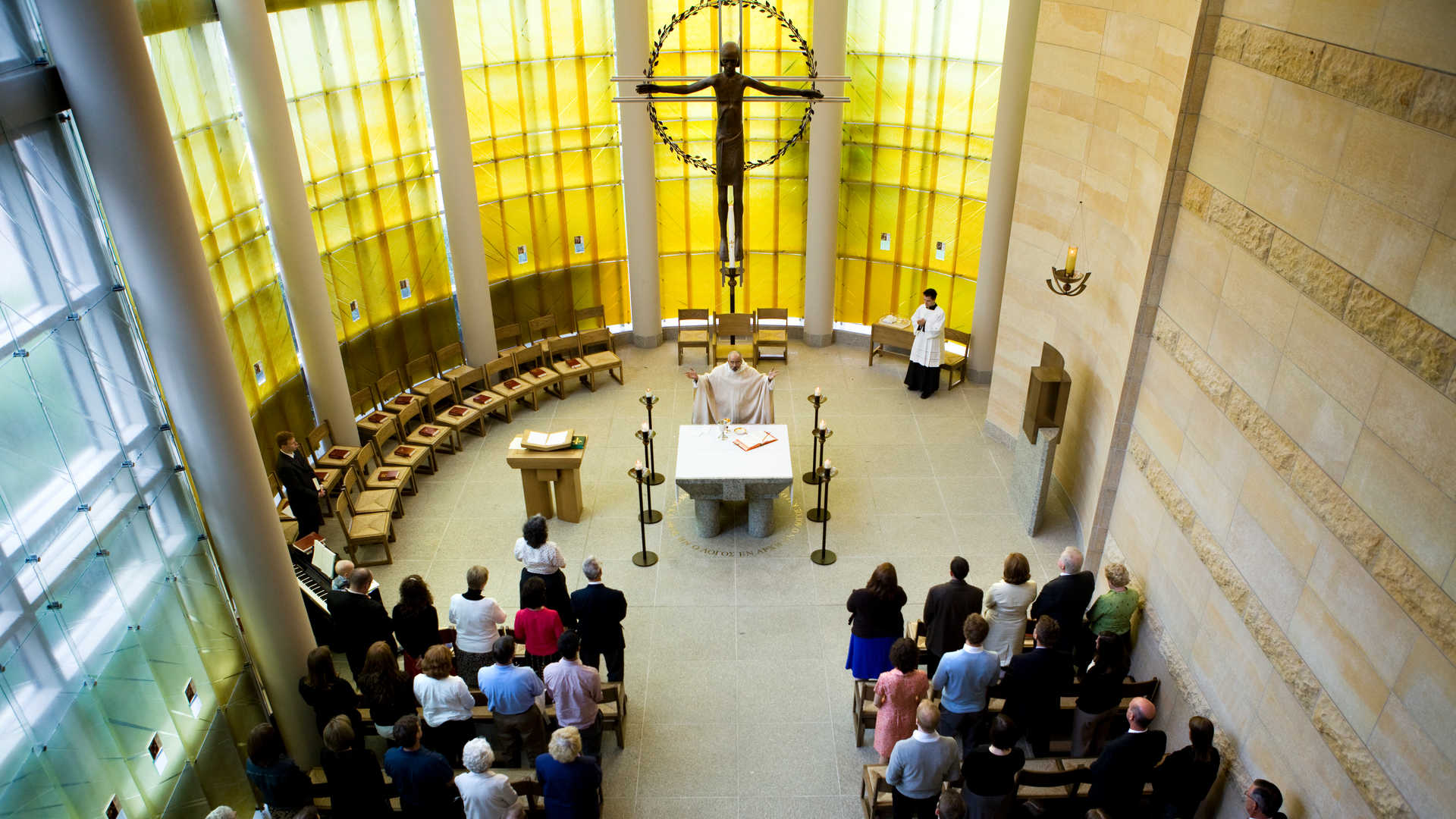 Father Reginald Whitt conducts a commencement mass in the St. Thomas More chapel