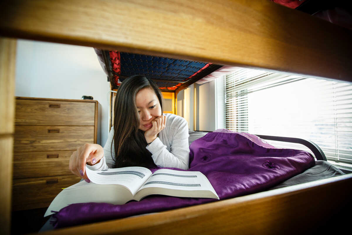 student reading on a bed
