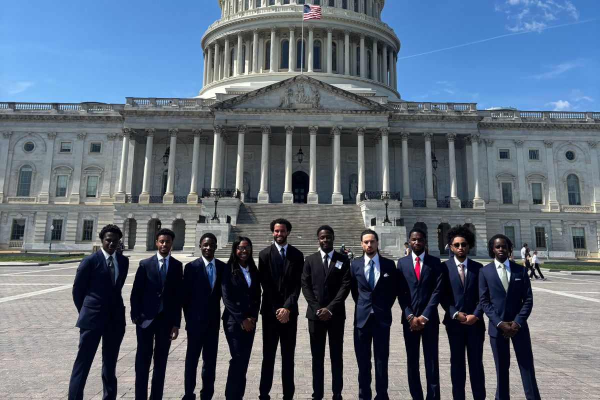 Group of students in suits outside of the Capitol building 