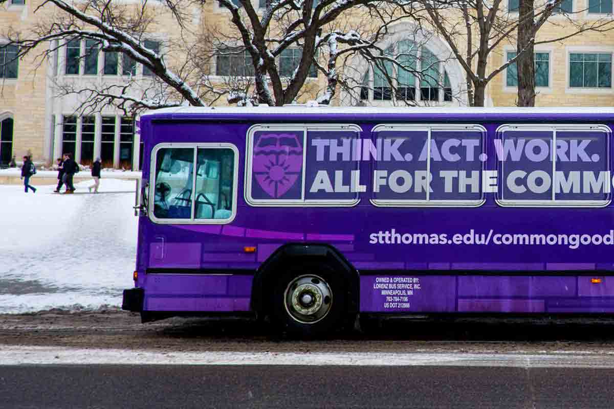 The St. Thomas shuttle bus drives near Summit Avenue.