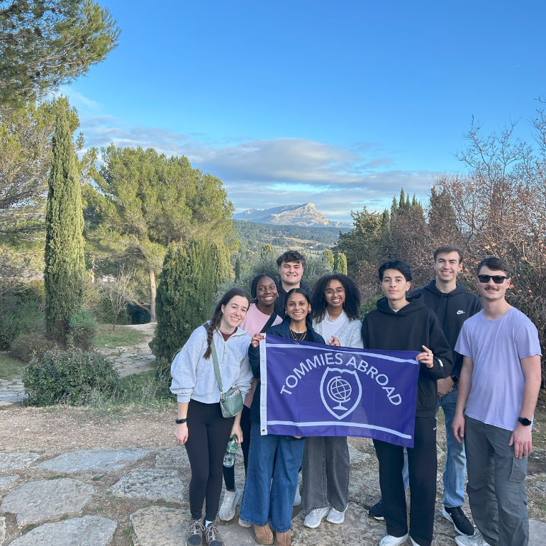 students standing in front of scenic mountain overlook