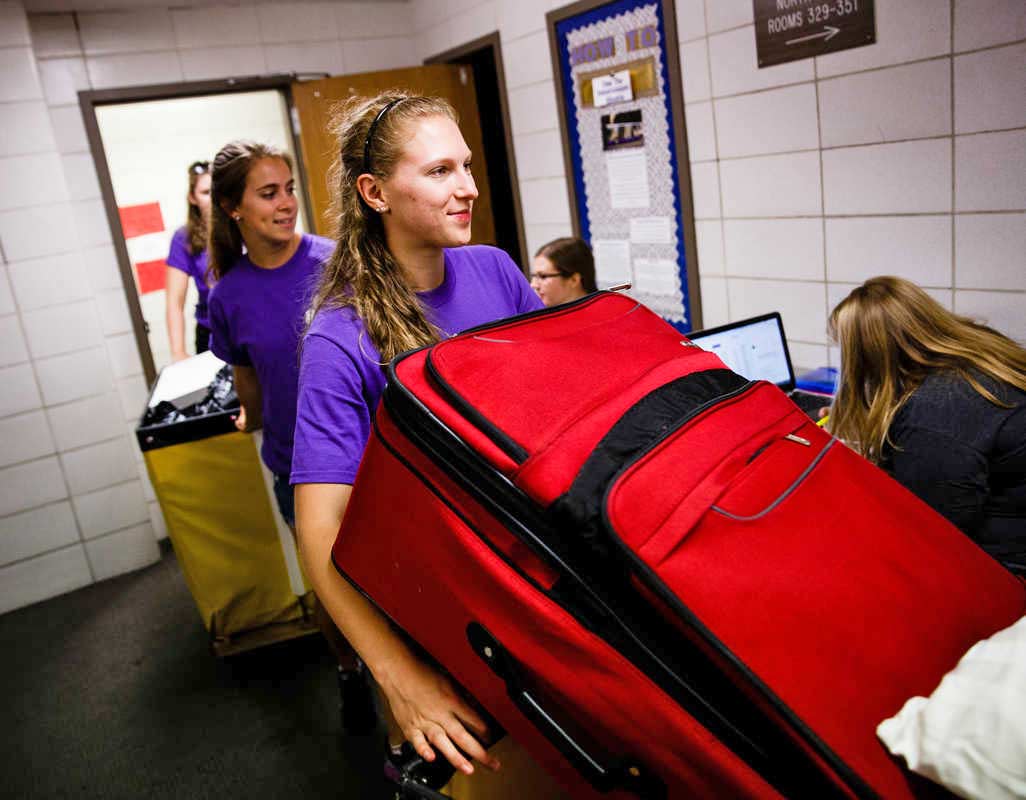 Members of Sully's Crew haul a student's belongings into Dowling Hall September 2, 2016 during freshmen Move-In Day.