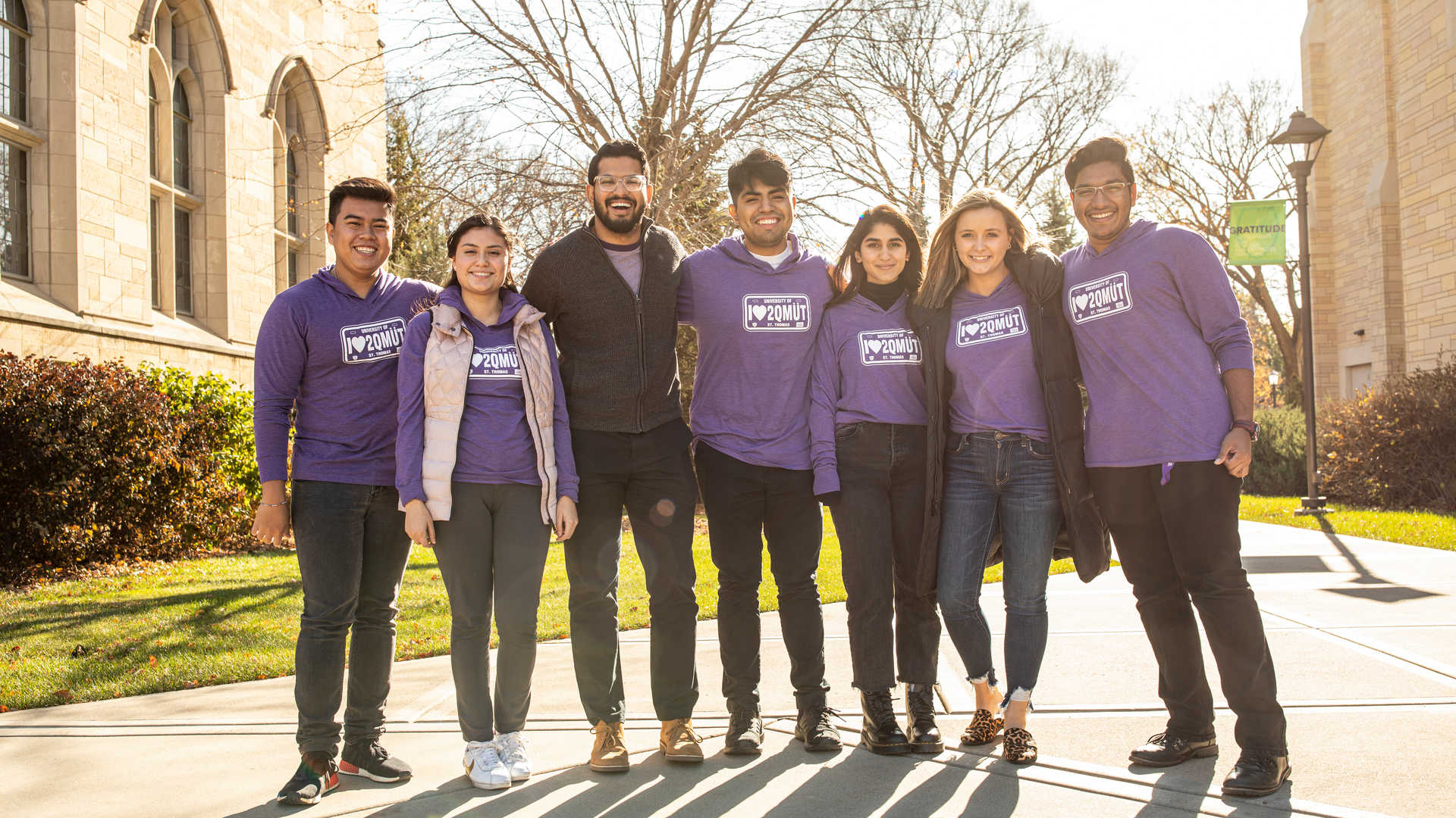 Students pose in commuter t-shirts in a photo shoot for Off Campus Student Life in and around the Anderson Student Center on November 5, 2019, in St. Paul.