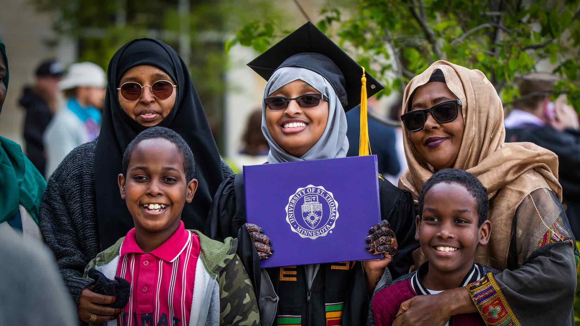 An international graduate poses with their family