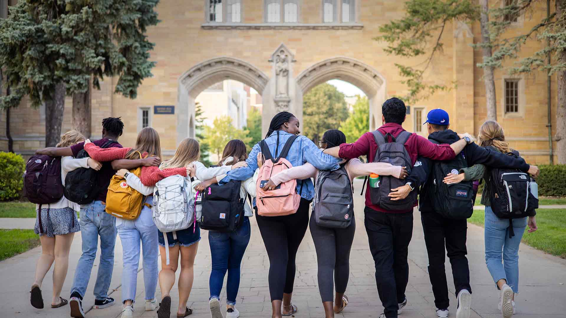 International students walking near arches.