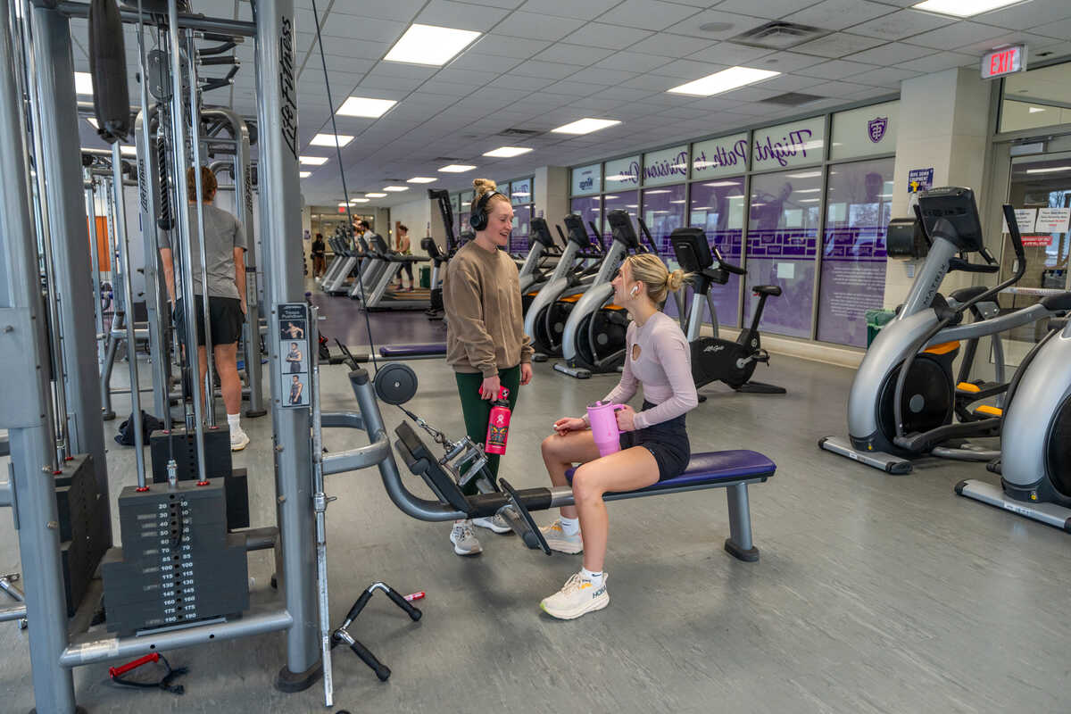 students chat in the aarc cardio and weight room