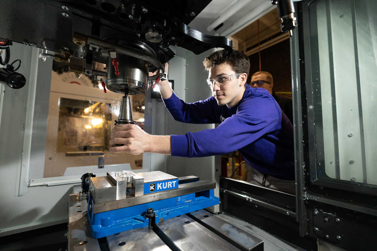 Student using machinery in Engineering Center