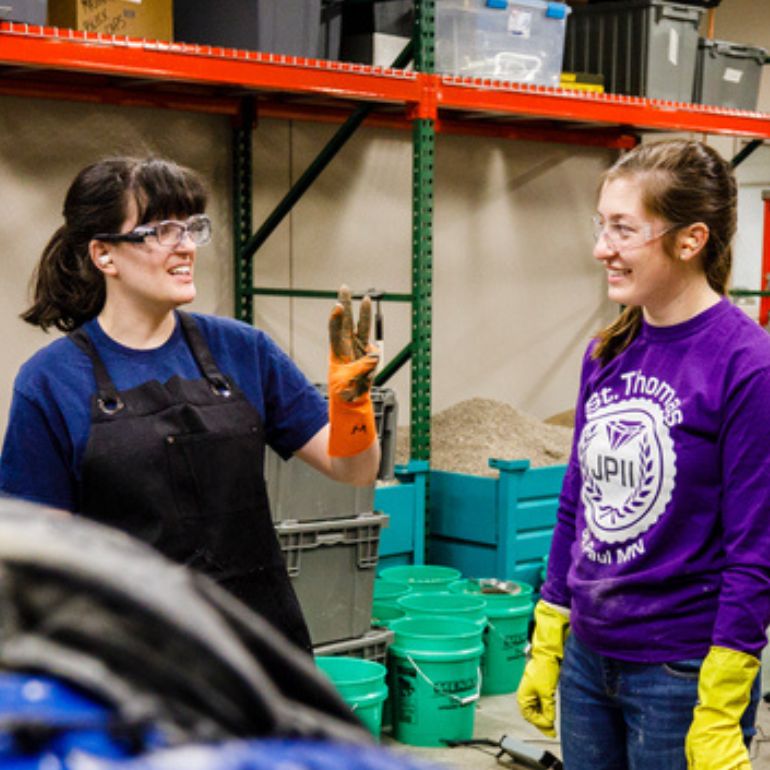 Dr. Rita Lederle talks with a student in the lab.