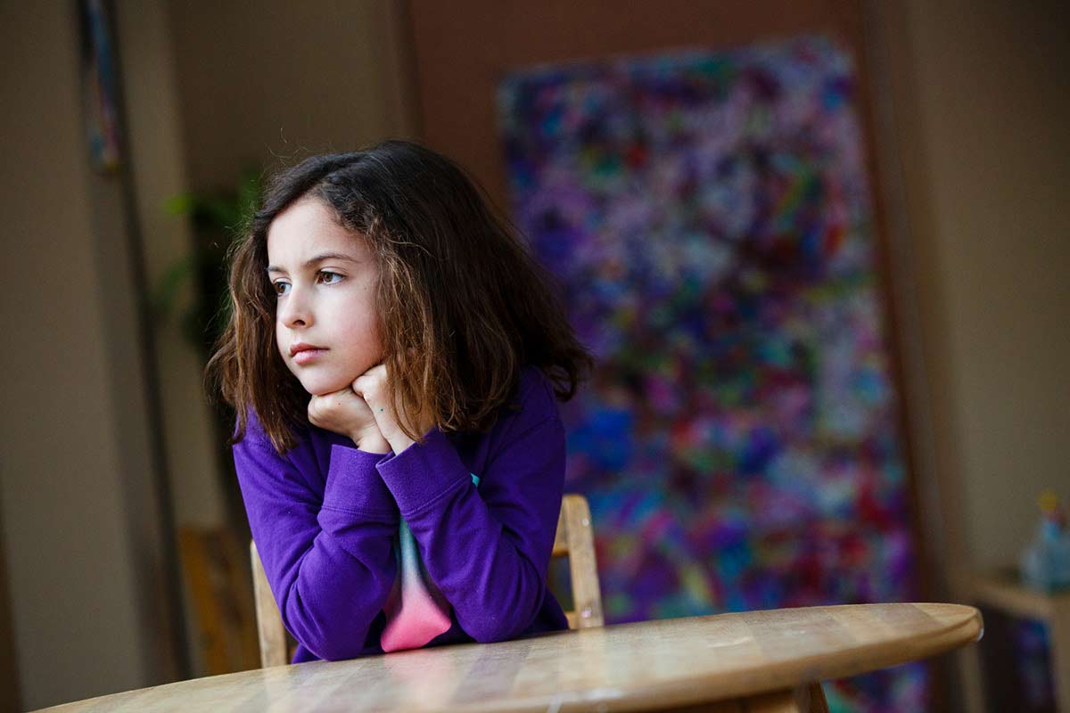 Young girl sits at table 