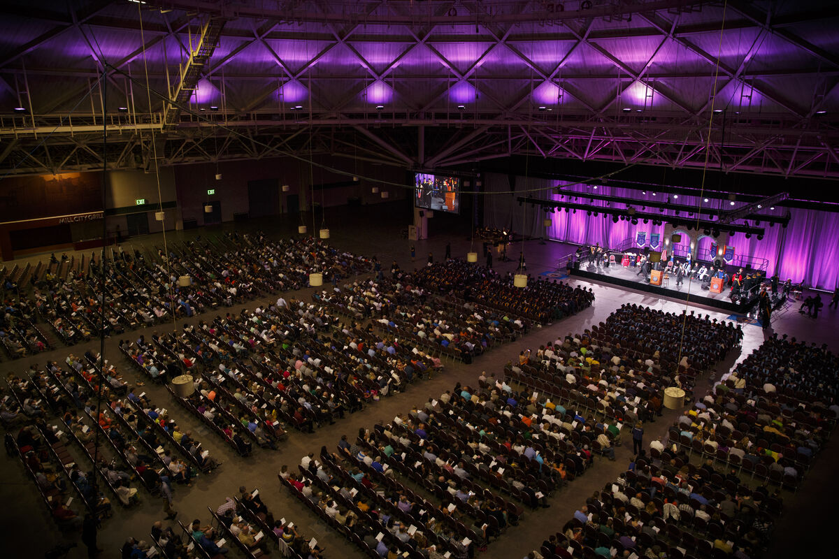 overhead view of people in a large auditorium with purple lighting