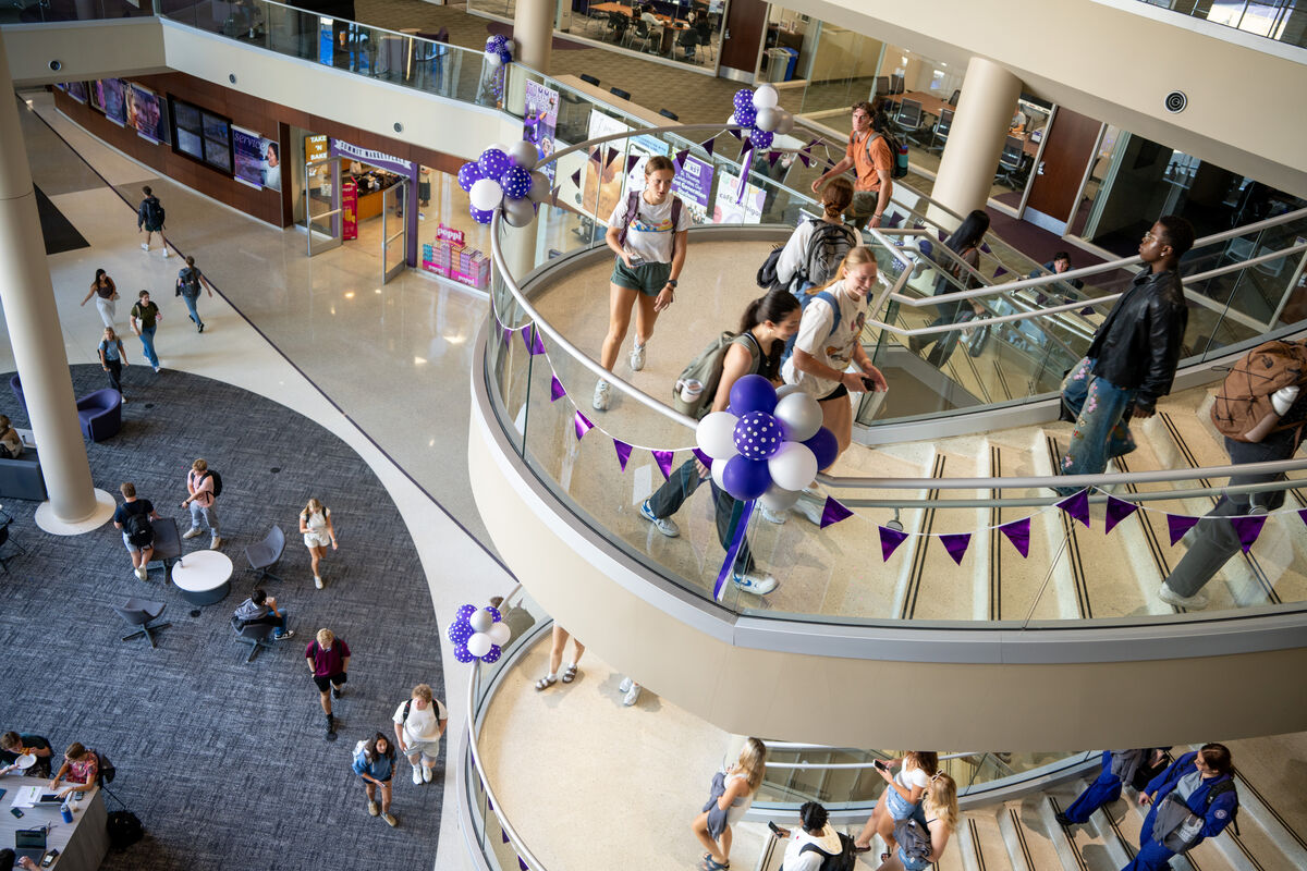 students walk up the spiral staircase at Anderson student center