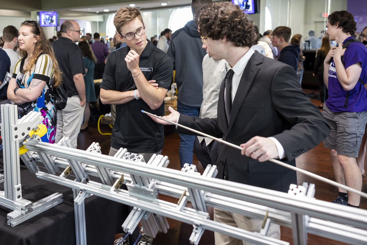 student explains engineering project involving metal rods