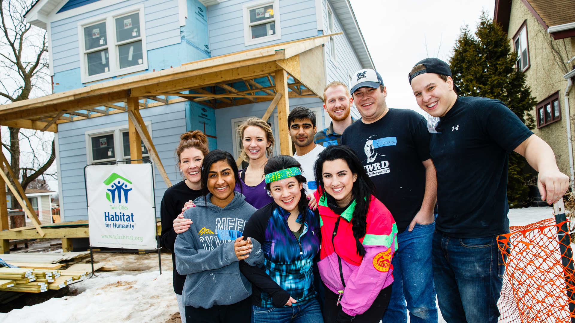 Tommies in front of a Habitat for Humanity house
