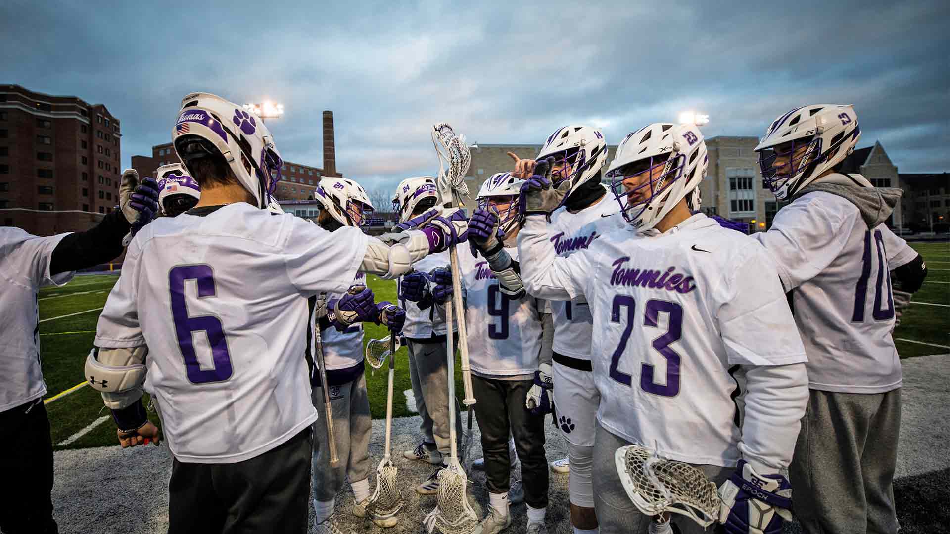 Lacrosse players high fiving