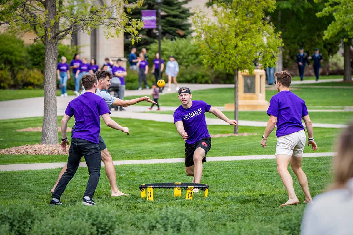 Students playing spikeball on lower quad