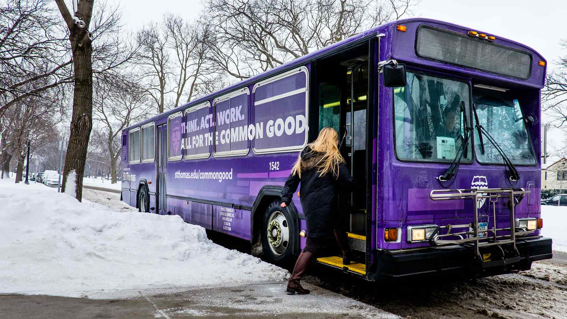 A student boards the St. Thomas shuttle bus.