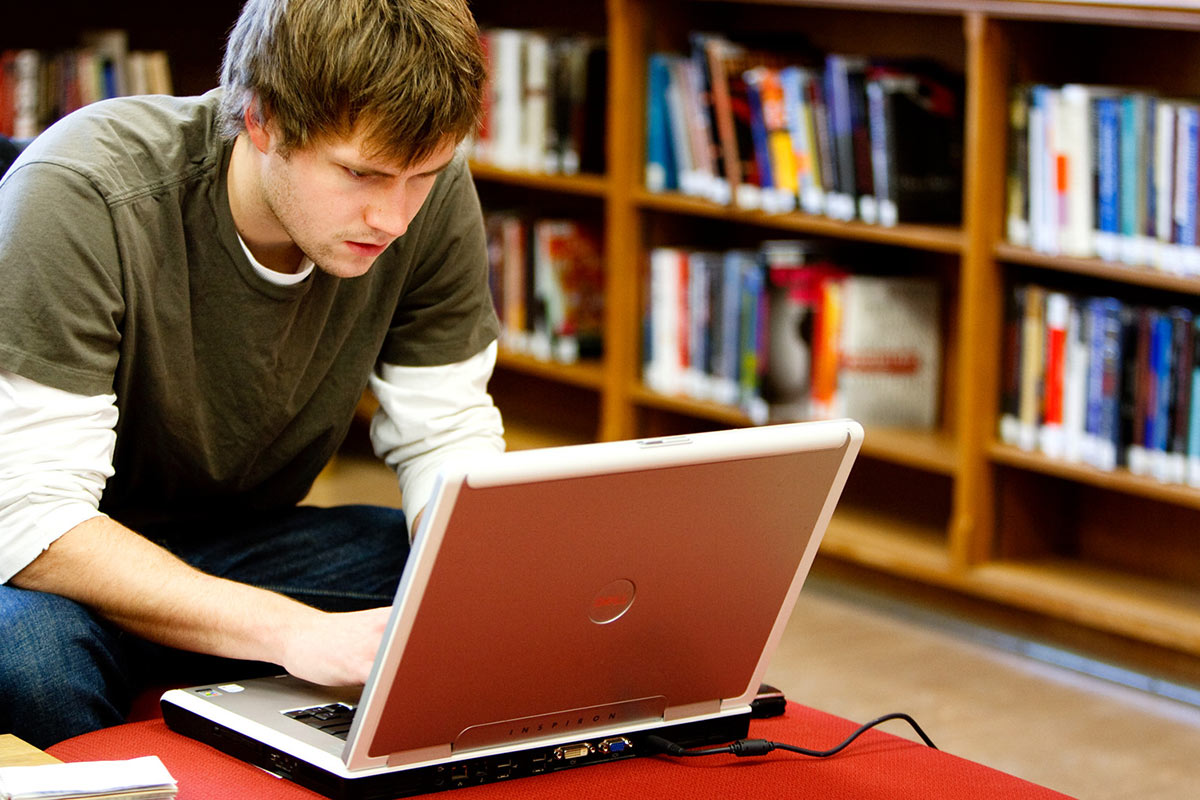 Student works on a laptop in O'Shaughnessy Frey Library.