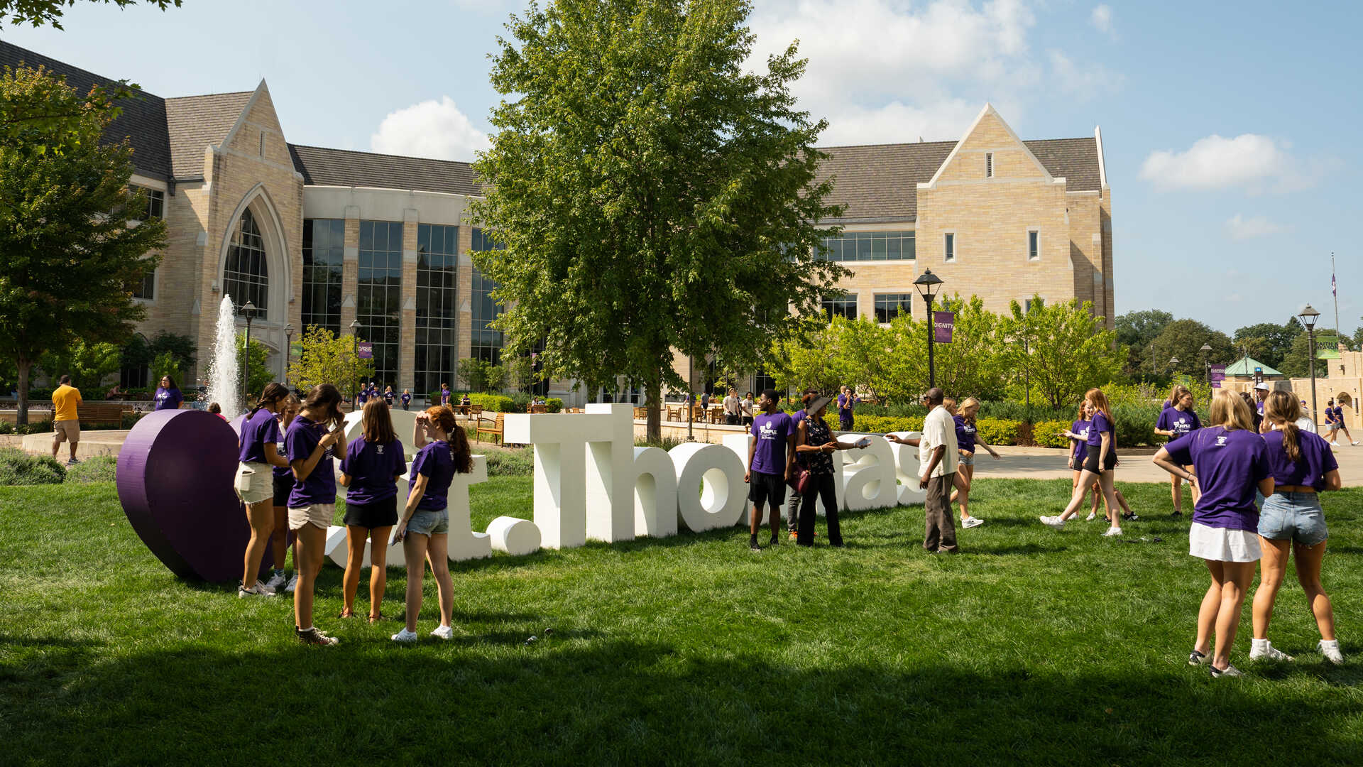 Students standing next to giant letters