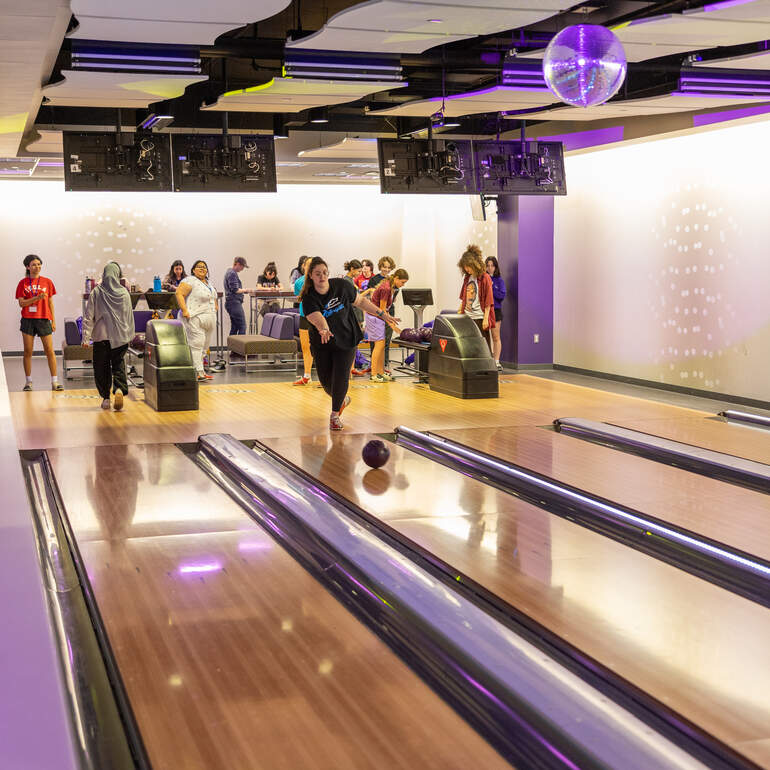 student bowling in the bowling alley of ASC