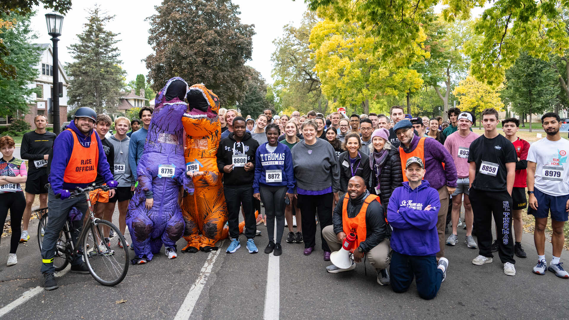 students faculty and staff pose at a 5k run walk event