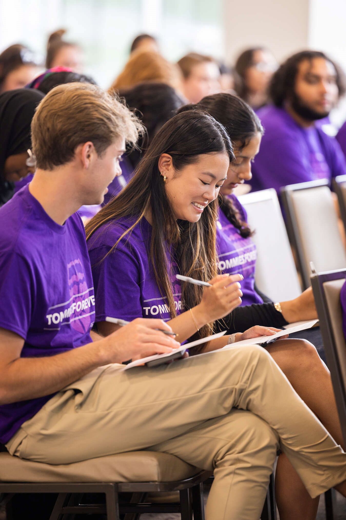 students wearing purple tee shirts and smiling.