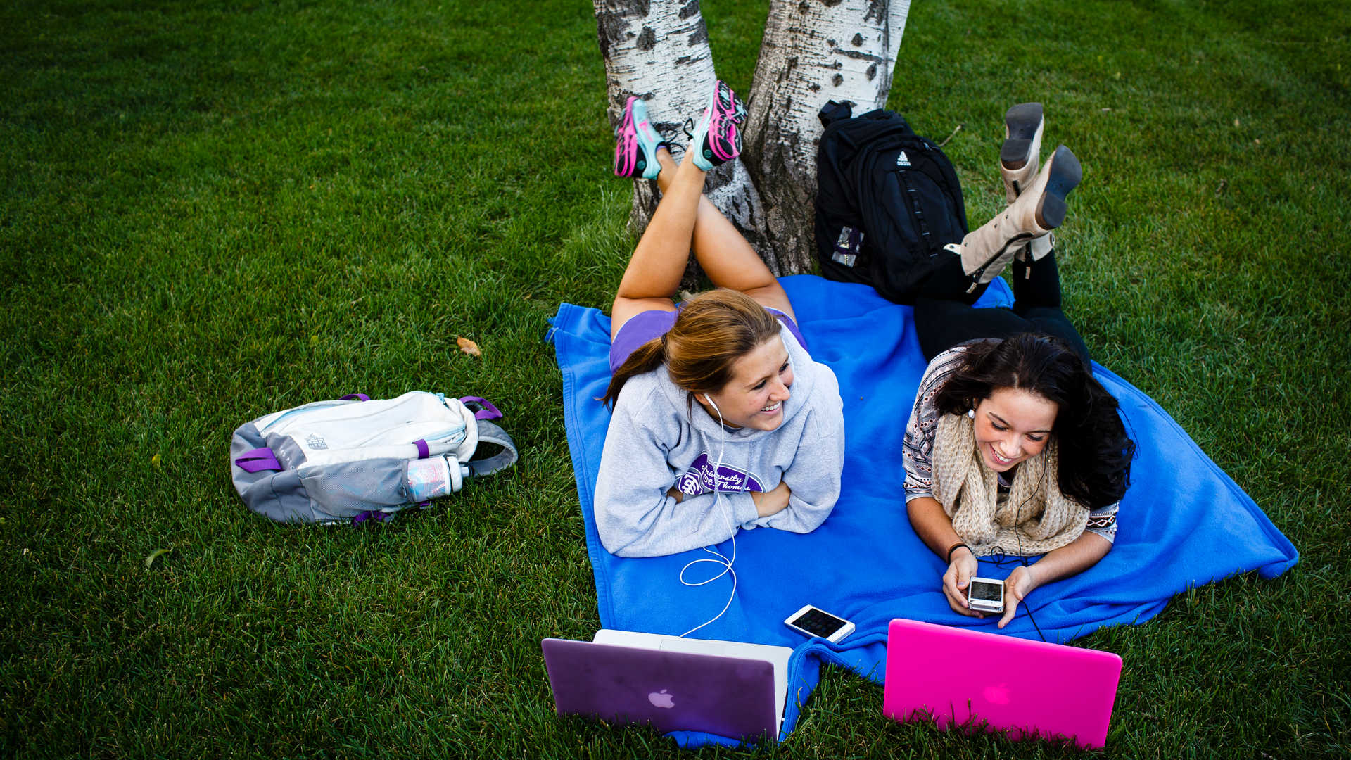 students outside on their laptops