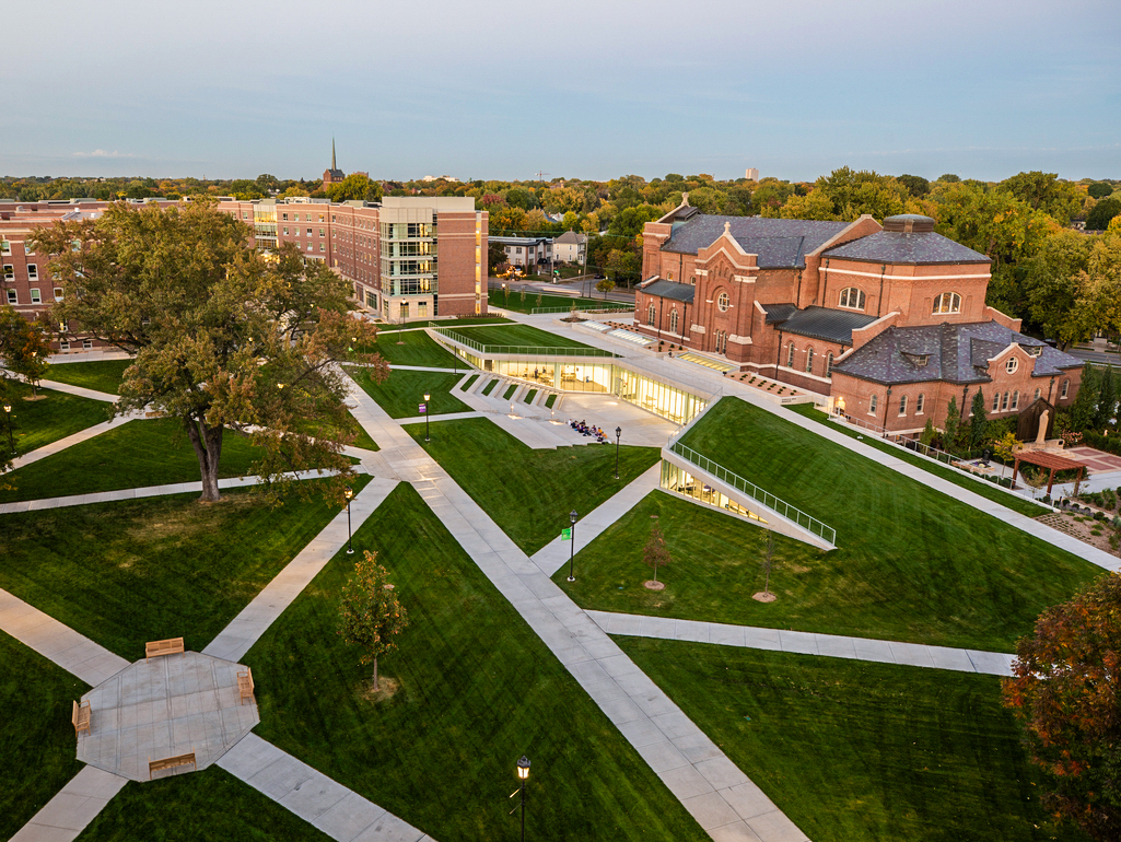 A wide view of the upper quad featuring the Iversen Center for Faith, Aquinas Chapel, Tommie North Residence Hall, and Ireland Hall as photographed at dusk on the rooftop of Brady Hall in St. Paul on September 29, 2020.