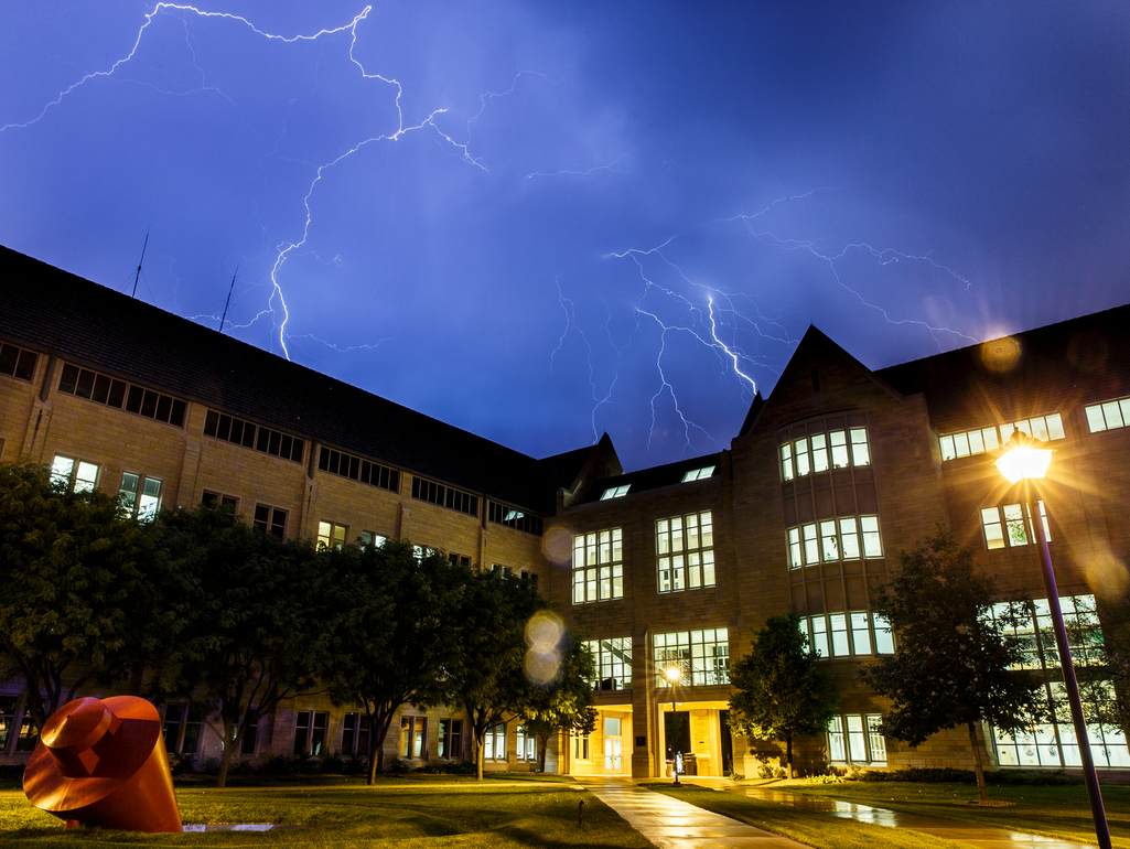 Lightning flashes over the Frey Science and Engineering Center's O'Shaughnessy Science Hall and Owens Science Hall on south campus on the evening of October 2, 2013. The sculpture "The Plunge" is seen on the bottom left of the frame.