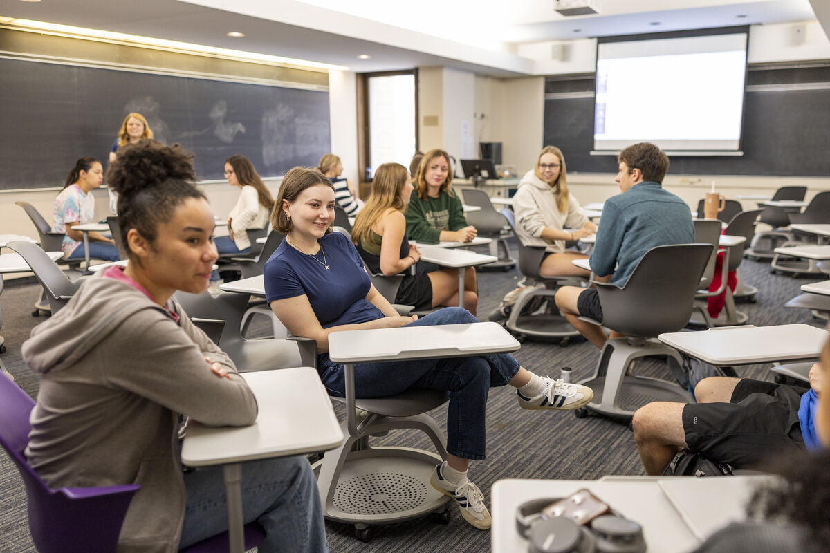 Students in a classroom talking with one another