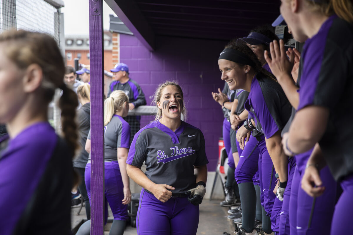 Softball players cheering in purple